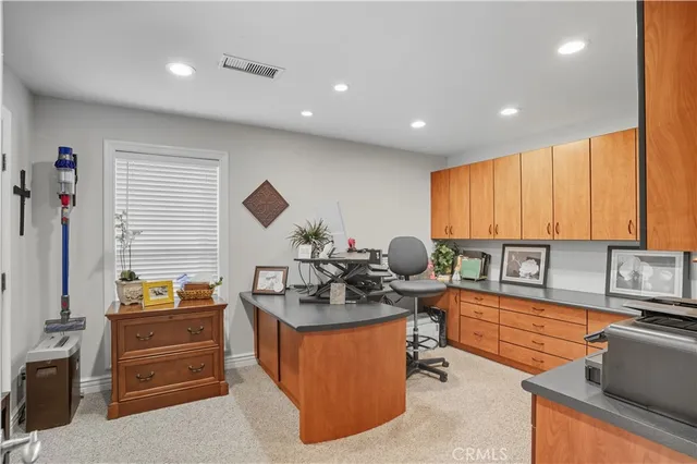 a large kitchen with granite countertop a sink counter space appliances and a living room view