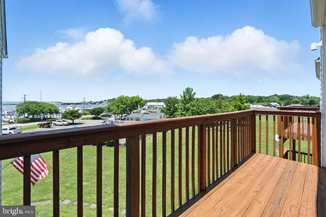 a balcony with wooden floor and city view
