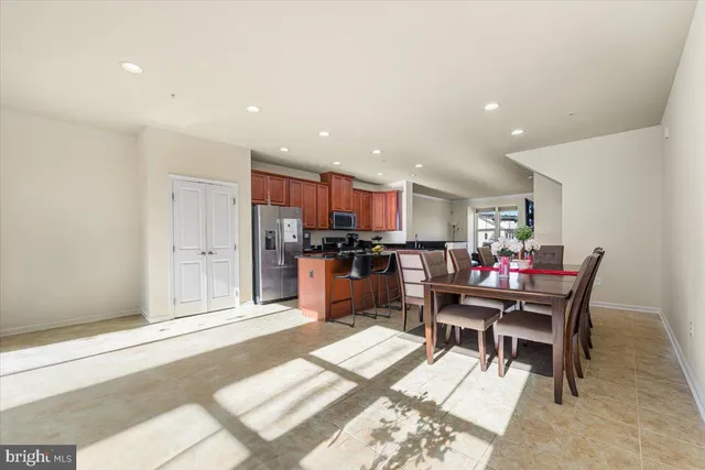 a living room with dining room and kitchen view
