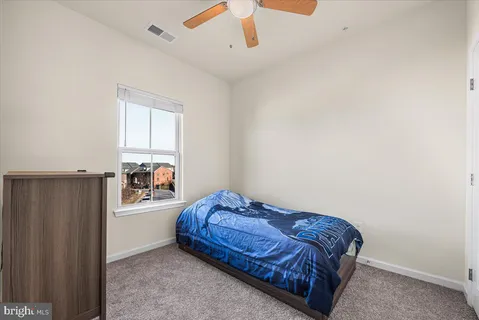 a view of a house with wooden stairs and a lawn chairs