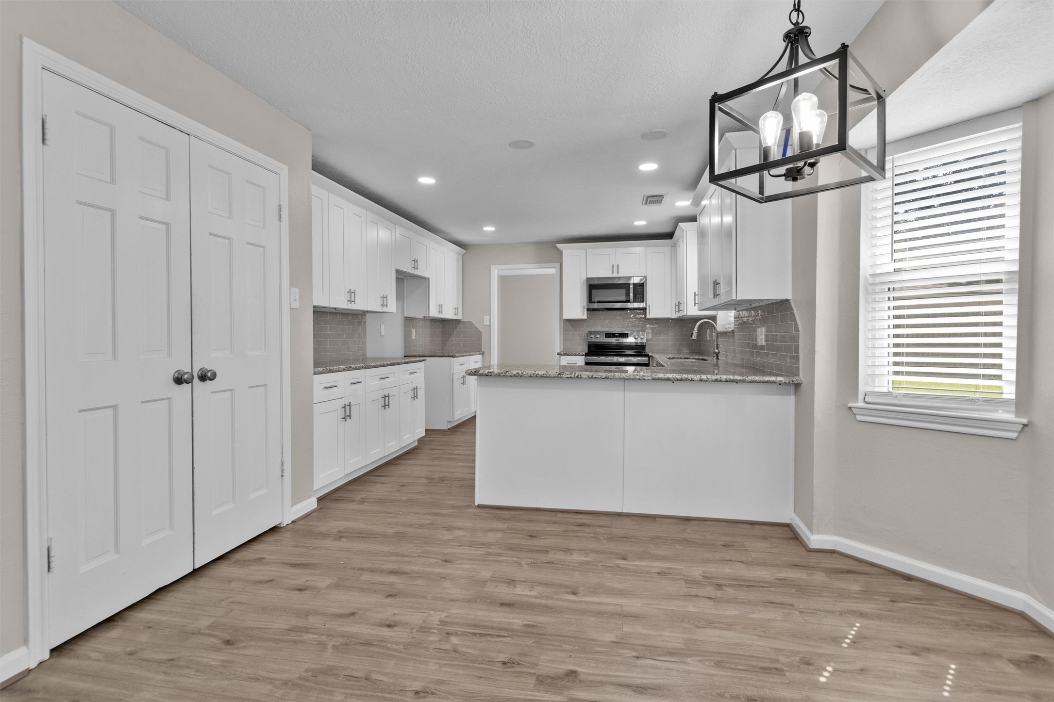 9115 Godstone Lane Spring, TX 77379 - Photo 16 of 46 Enjoy a seamless view from the cozy breakfast nook into the modern, spacious kitchen.