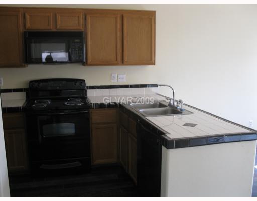 2121 Sun Swept Way Henderson, NV 89074 - Photo 2 of 12 Kitchen. Brand new upgraded appliances, new custom tile countertops, new hardwood floors!