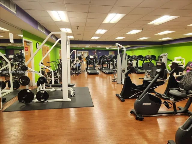 a room with gym equipment and a large window