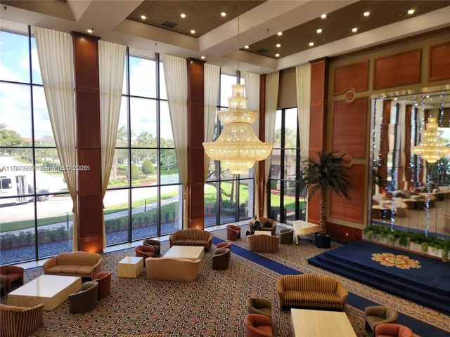 a living room with furniture and large windows