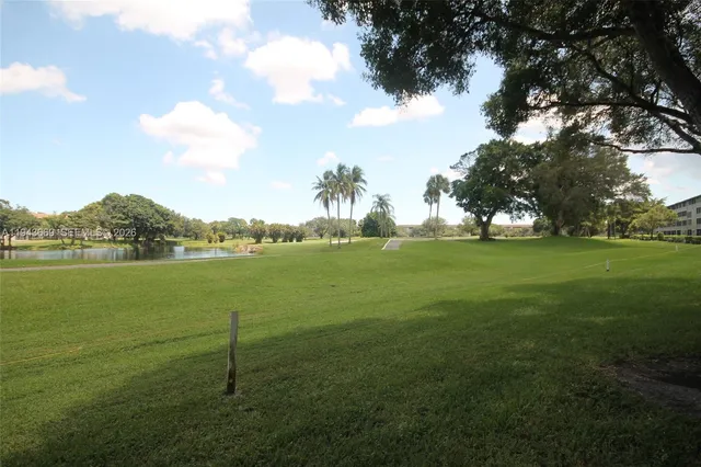 a view of a field with an trees