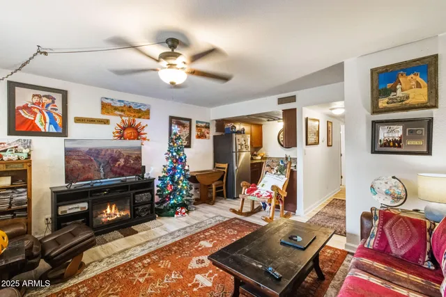 a living room with furniture a flat screen tv and a fireplace