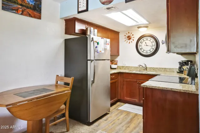 a kitchen with a refrigerator and a table