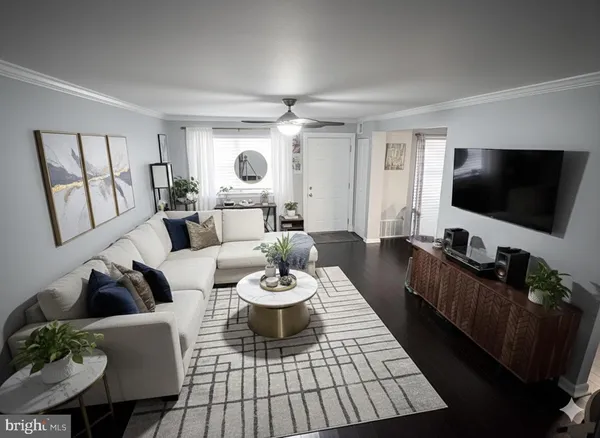 a dining room with furniture potted plants and wooden floor