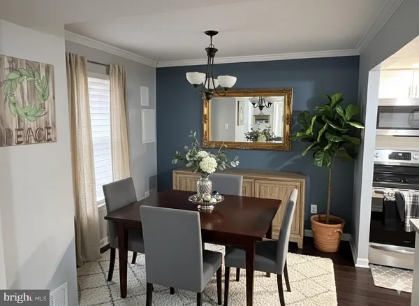 a kitchen with stainless steel appliances granite countertop a refrigerator a stove a sink and a microwave