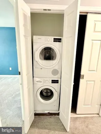a view of a house with a door and wooden bench
