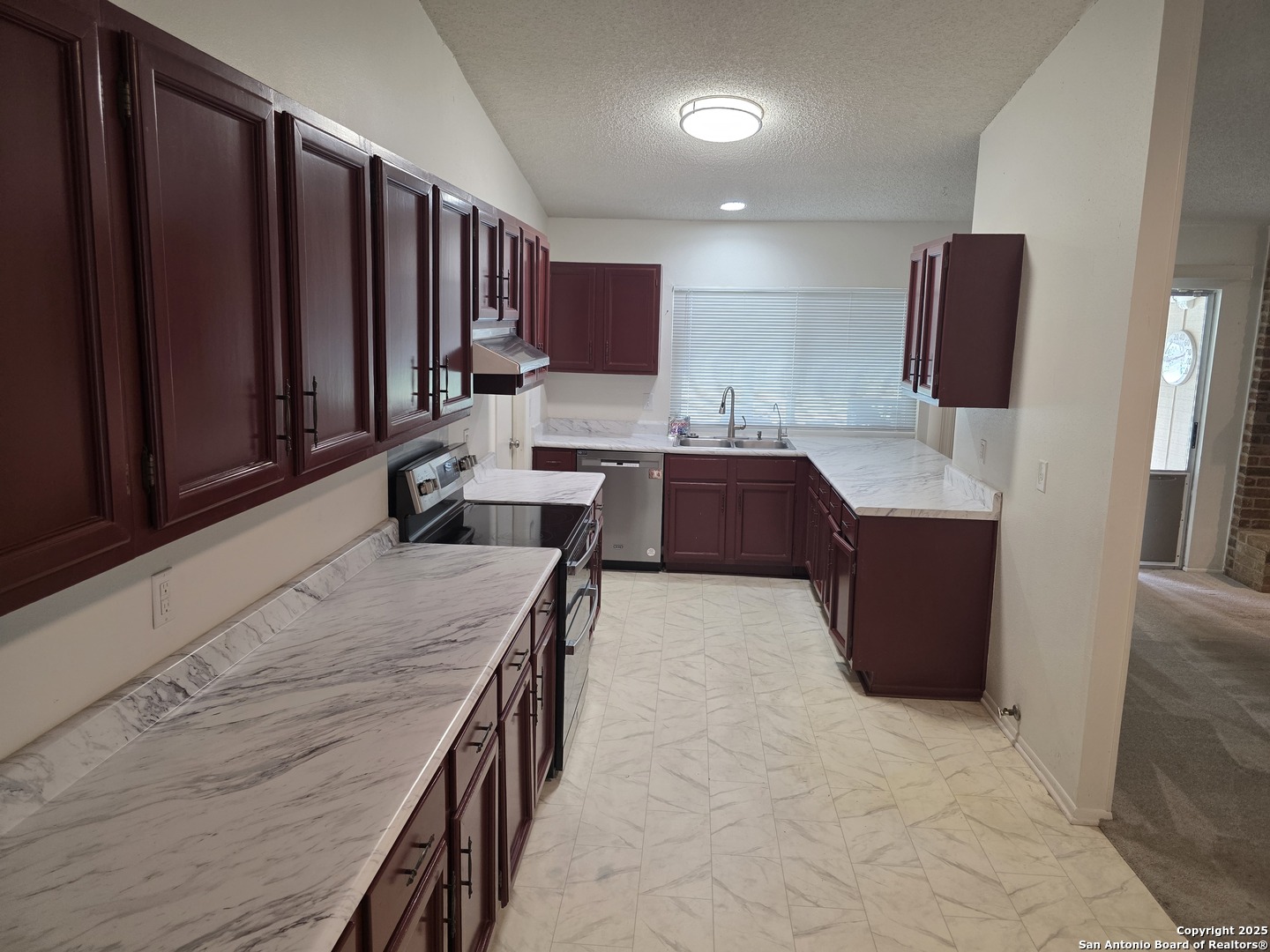 13339 Los Indios San Antonio, TX 78233 - Photo 3 of 17 a kitchen with stainless steel appliances microwave stove refrigerator and cabinets