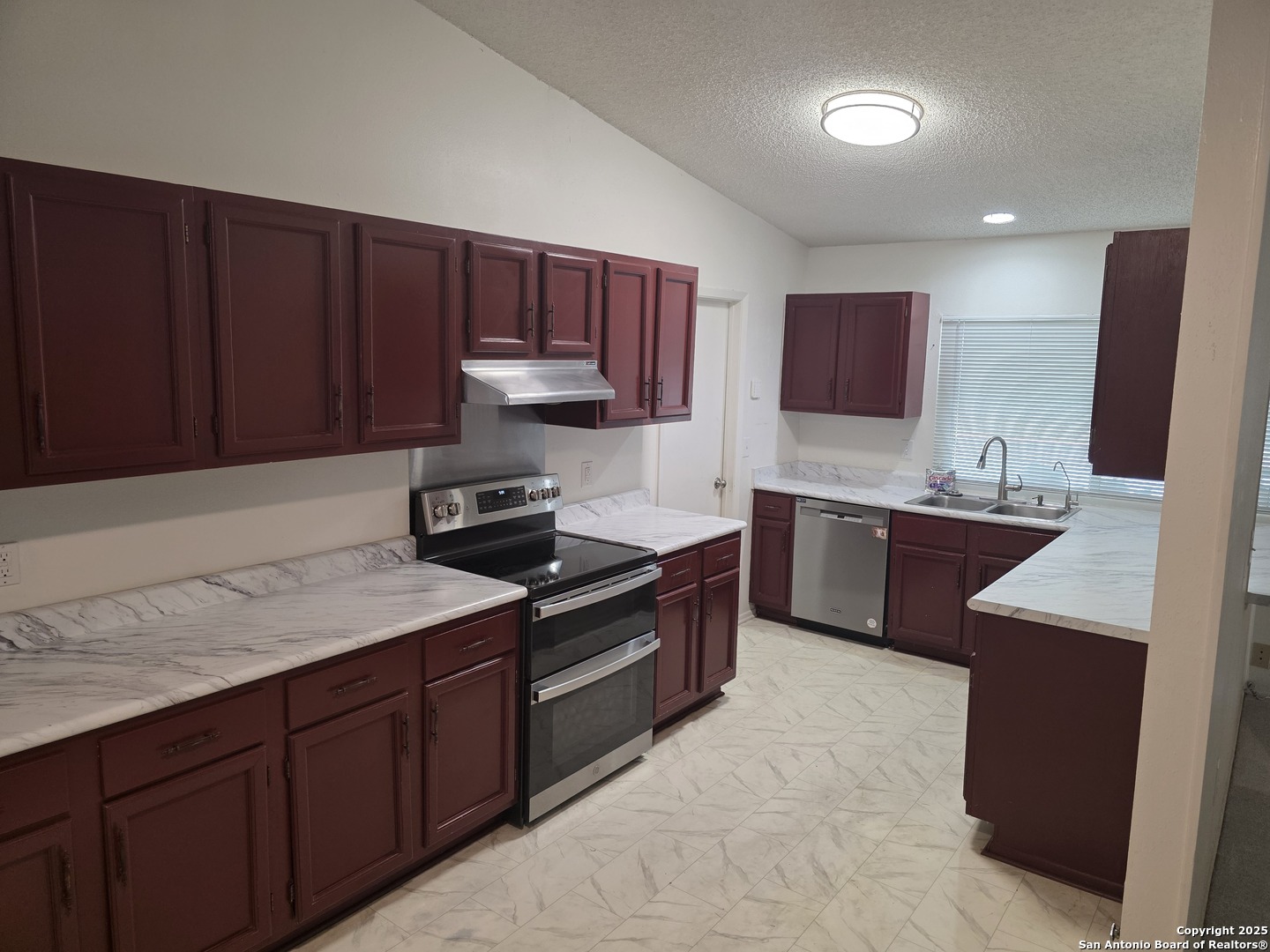 13339 Los Indios San Antonio, TX 78233 - Photo 4 of 17 a kitchen with a sink and a stove top oven with wooden floor