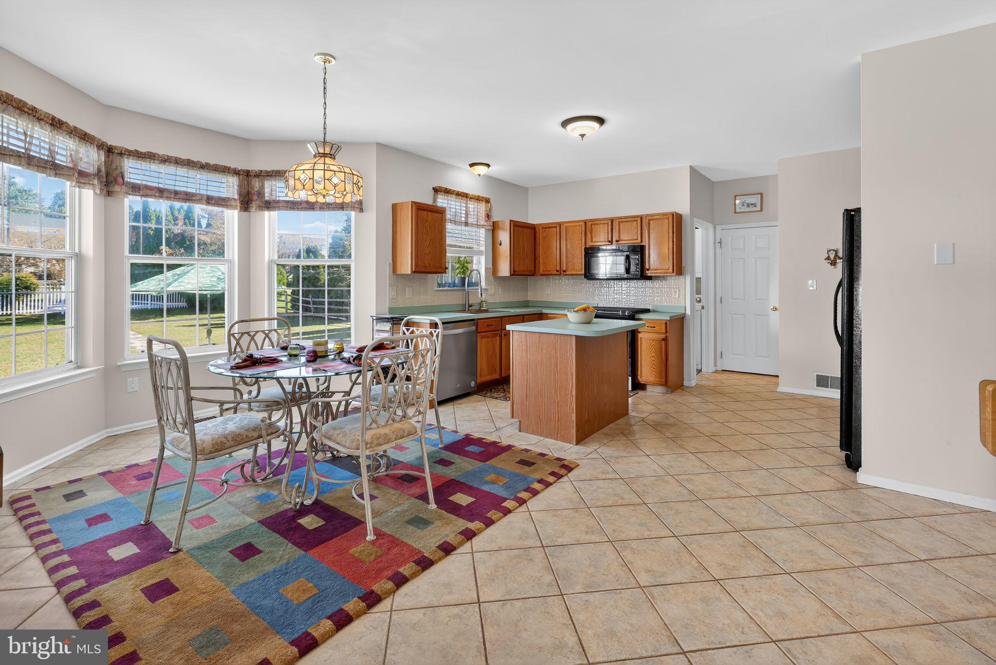 78 Emerald Ridge Drive Bear, DE 19701 - Photo 12 of 30 a very nice looking living room with a dining table wooden floor and a rug