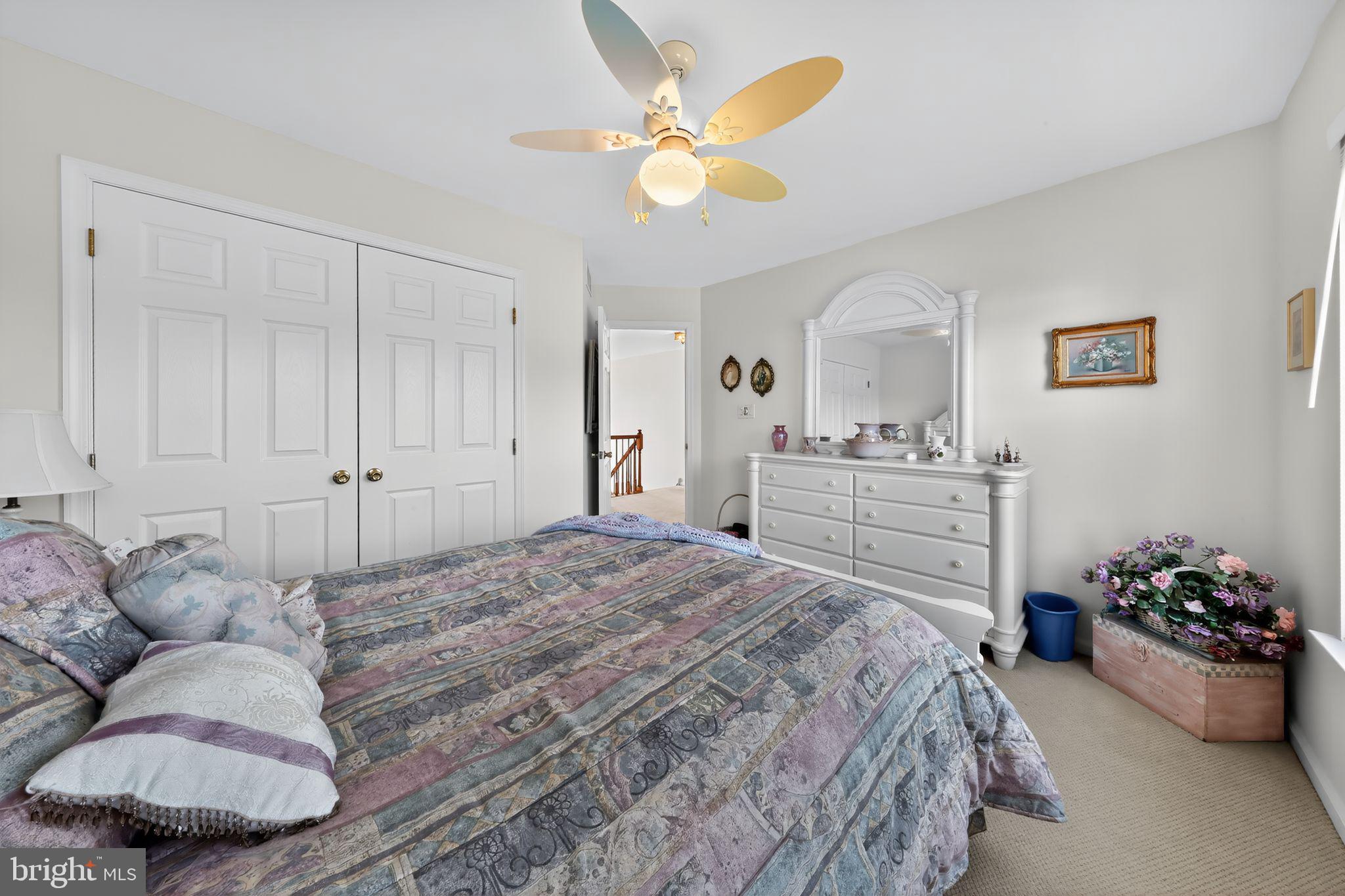 78 Emerald Ridge Drive Bear, DE 19701 - Photo 20 of 30 a spacious bedroom with a bed and a chandelier
