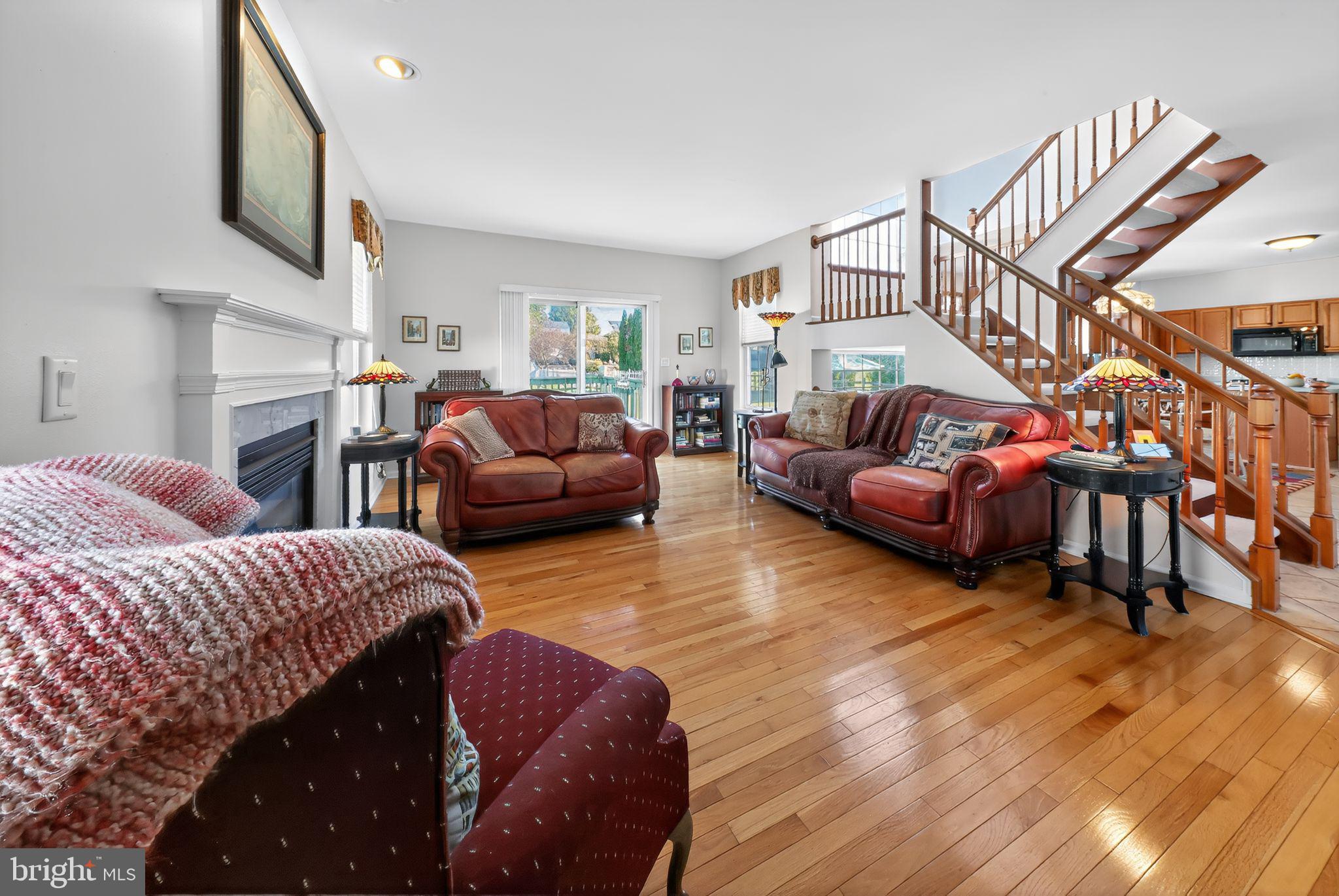 78 Emerald Ridge Drive Bear, DE 19701 - Photo 4 of 30 a living room with furniture a fireplace and a wooden floor