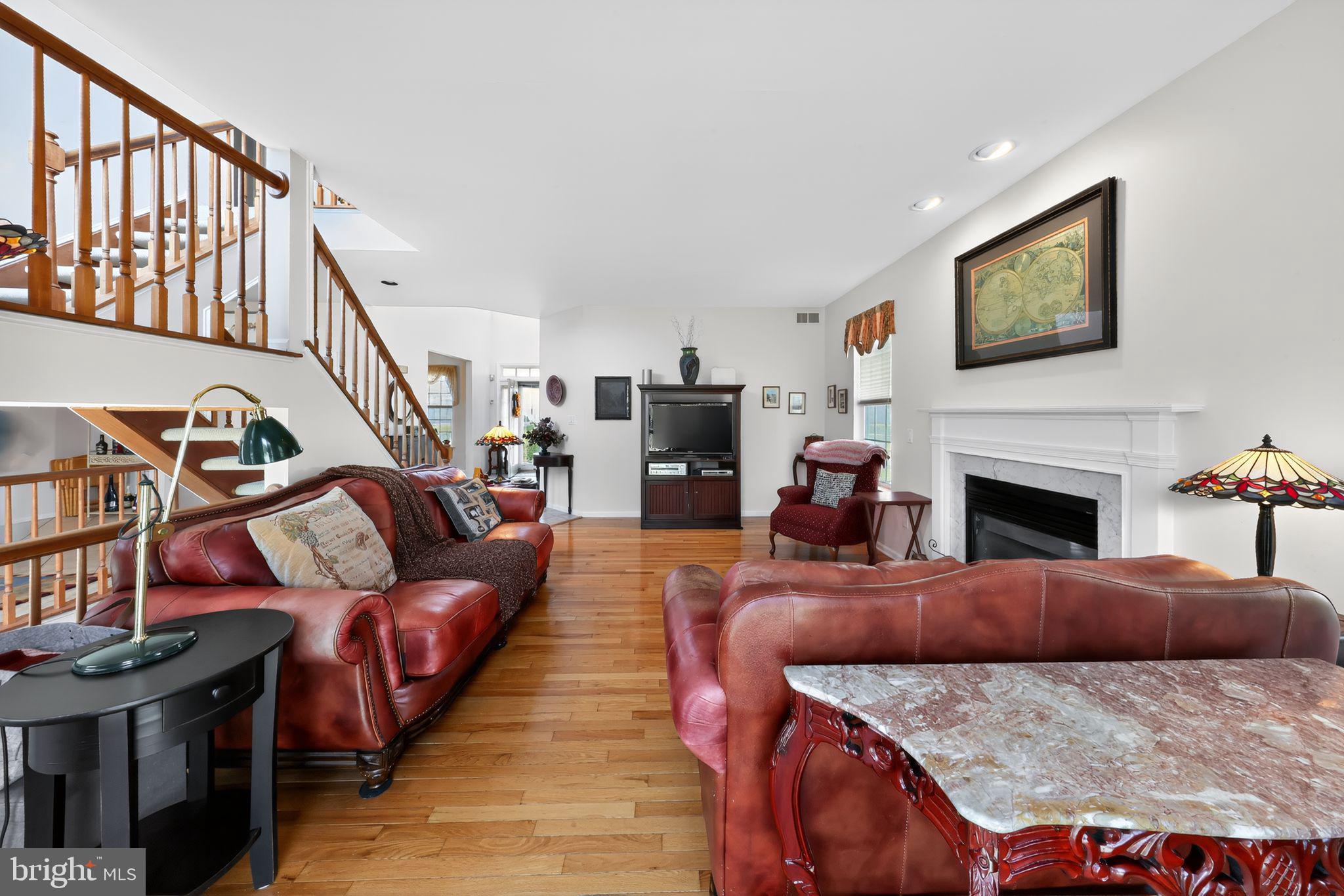78 Emerald Ridge Drive Bear, DE 19701 - Photo 5 of 30 a living room with furniture a flat screen tv and a fireplace