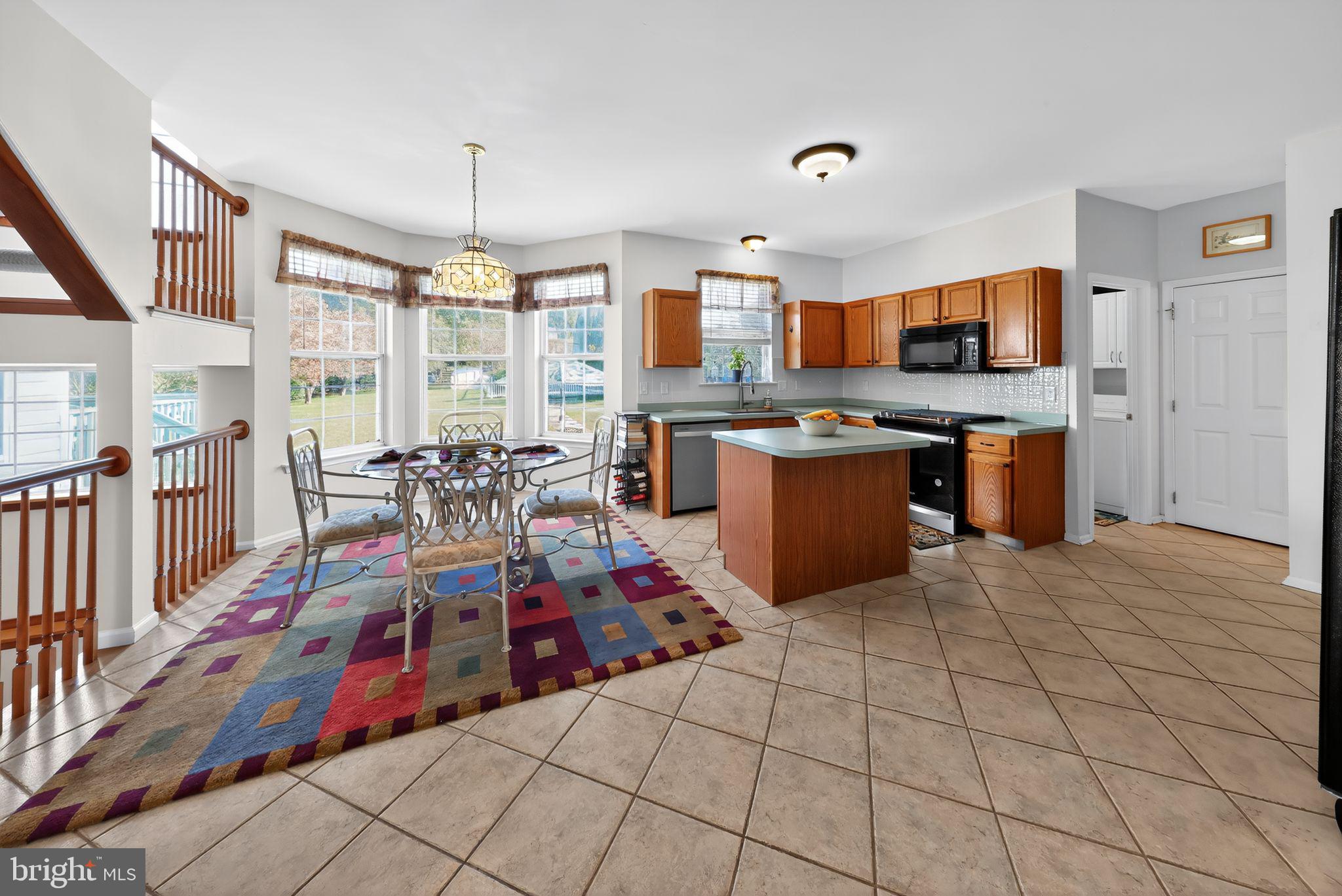 78 Emerald Ridge Drive Bear, DE 19701 - Photo 7 of 30 a very nice looking open kitchen with granite countertop a large counter top space and stainless steel appliances