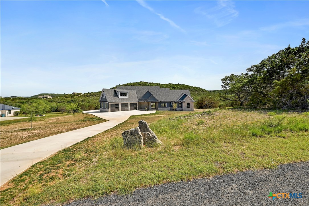 304 Spring Hollow Drive Bertram, TX 78605 - Photo 1 of 45 a view of a lake with a house in the background