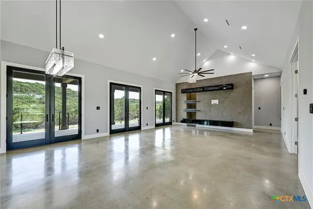 a large kitchen with stainless steel appliances kitchen island a large counter top and a stove