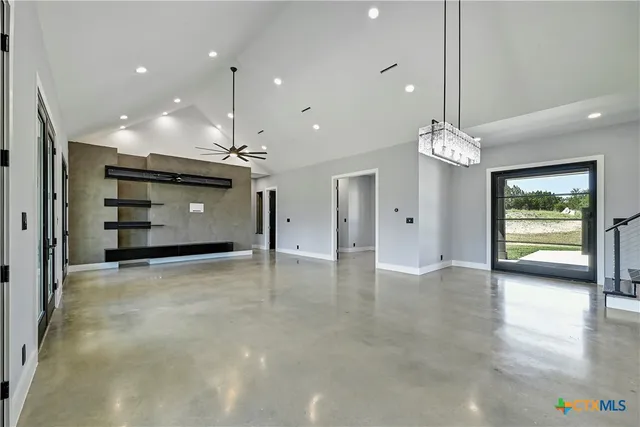 a view of a livingroom with furniture a ceiling fan and window