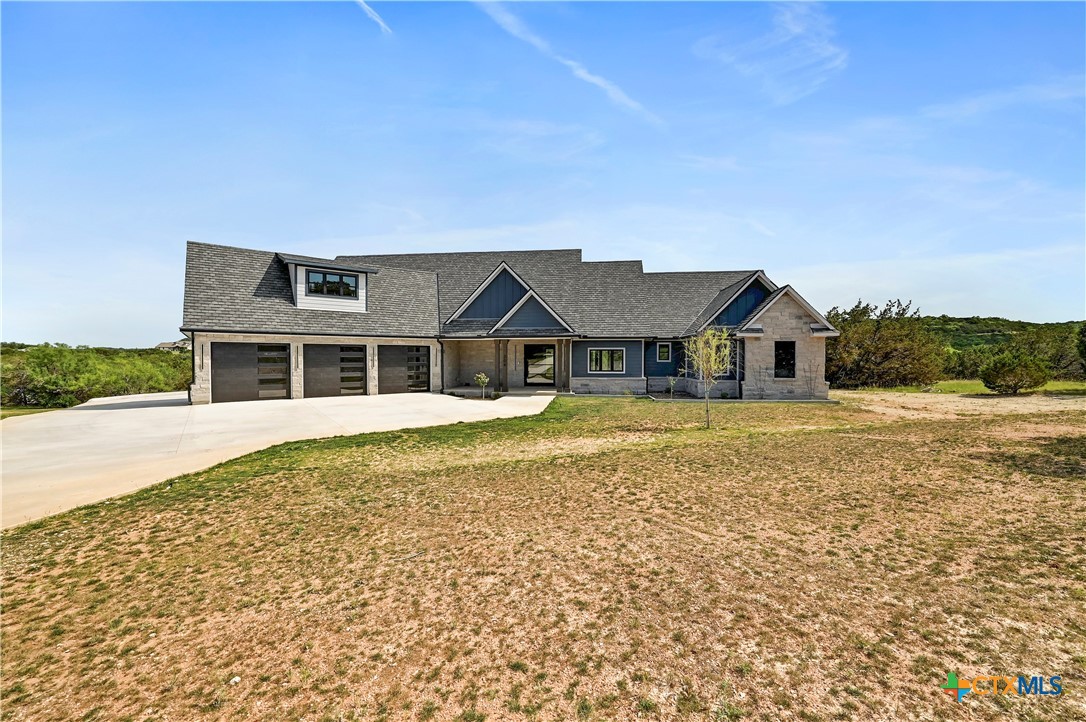 304 Spring Hollow Drive Bertram, TX 78605 - Photo 3 of 45 a front view of a house with a yard