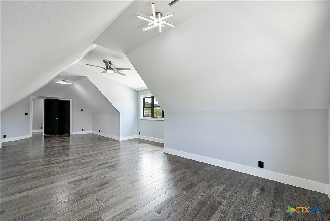 304 Spring Hollow Drive Bertram, TX 78605 - Photo 31 of 45 an empty room with wooden floor fan and windows