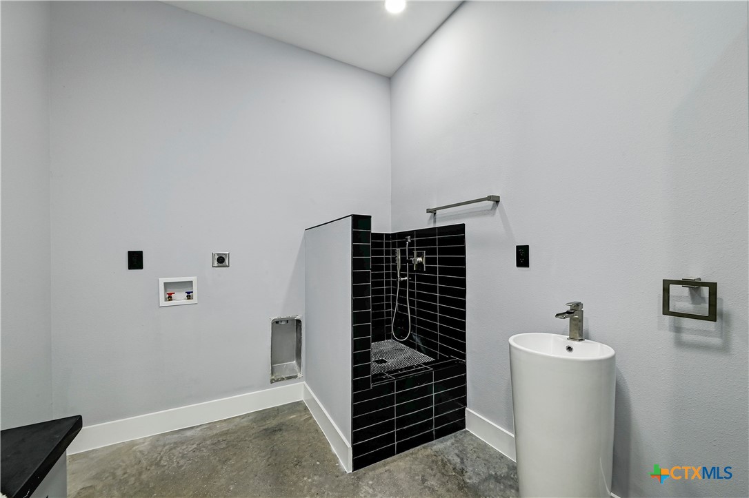 304 Spring Hollow Drive Bertram, TX 78605 - Photo 34 of 45 a bathroom with a sink and a mirror