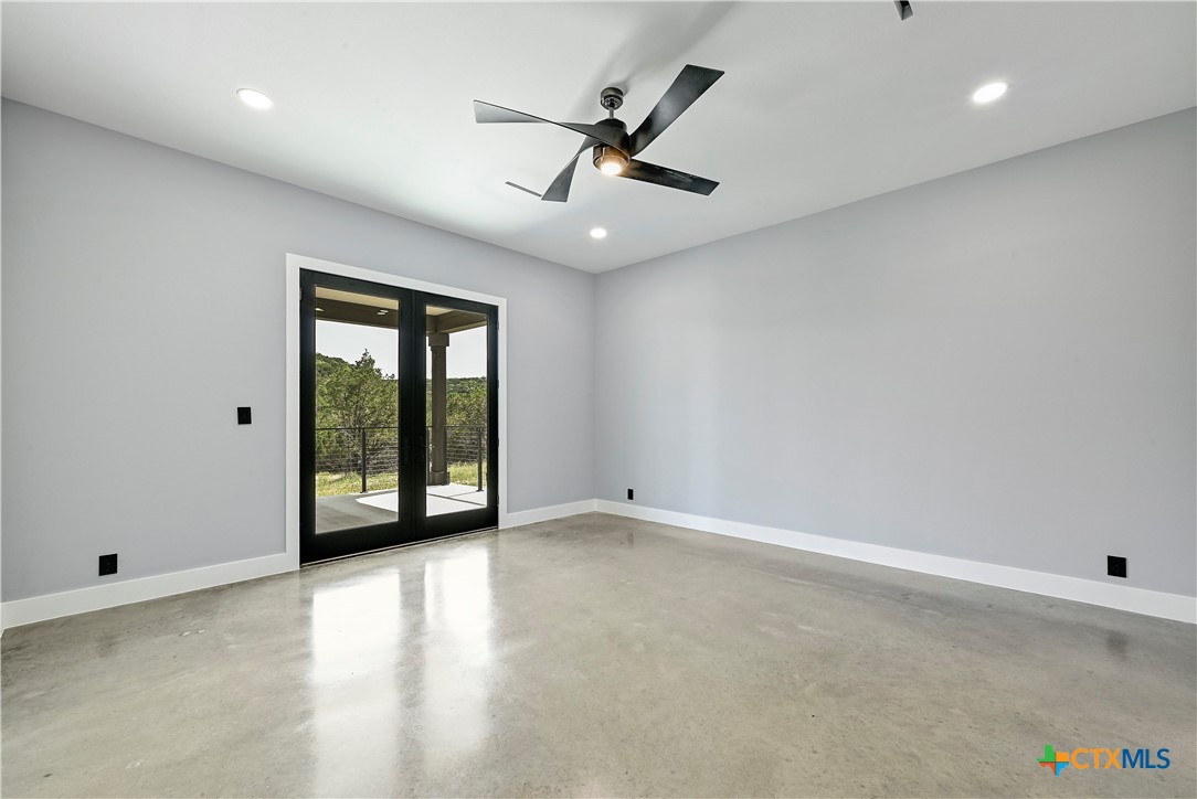 304 Spring Hollow Drive Bertram, TX 78605 - Photo 39 of 45 an empty room with windows and fan