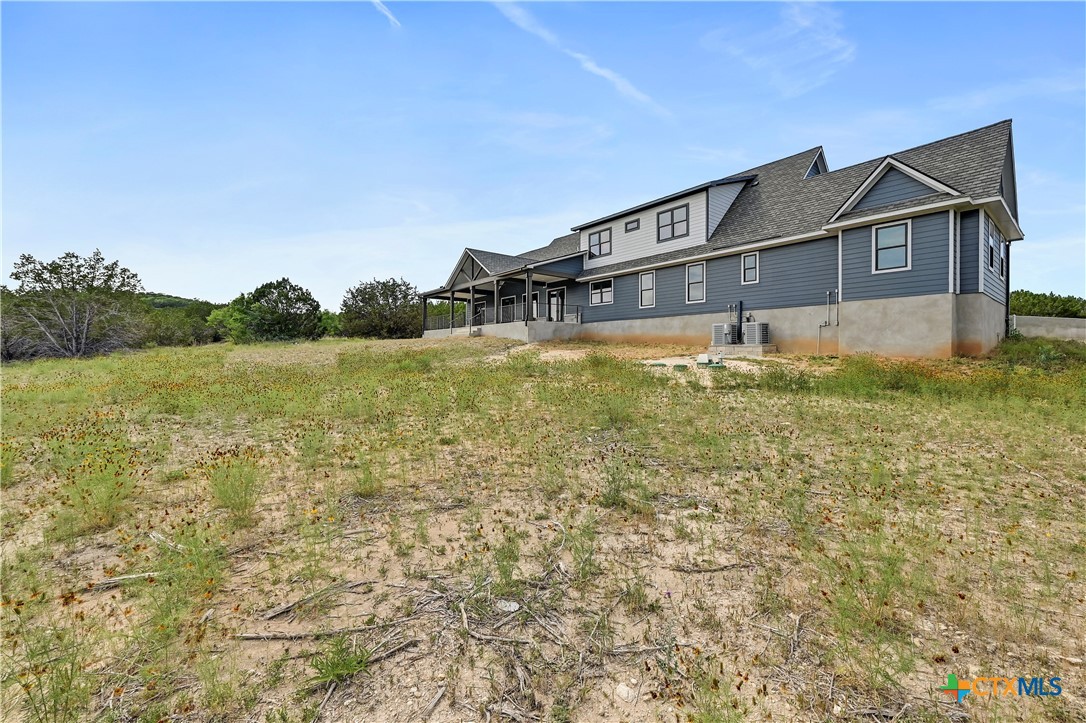 304 Spring Hollow Drive Bertram, TX 78605 - Photo 45 of 45 a front view of a house with a yard