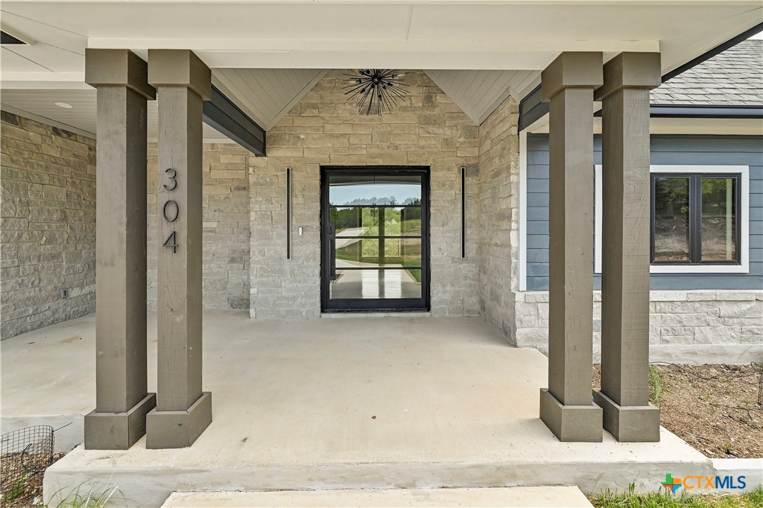304 Spring Hollow Drive Bertram, TX 78605 - Photo 8 of 45 a front view of a house with a floor to ceiling window
