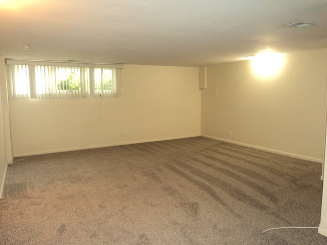 19-w286 Governors Trail Oak Brook, IL 60523 - Photo 12 of 17 an empty room with wooden floor and windows