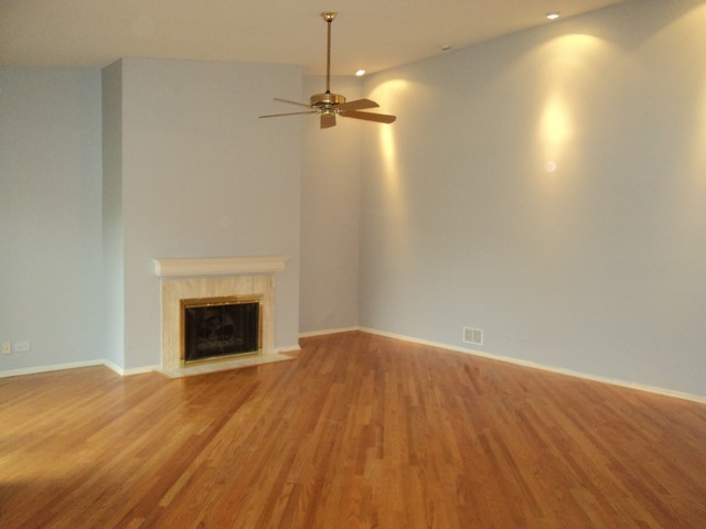 19-w286 Governors Trail Oak Brook, IL 60523 - Photo 3 of 17 a view of an empty room with wooden floor fireplace and a window