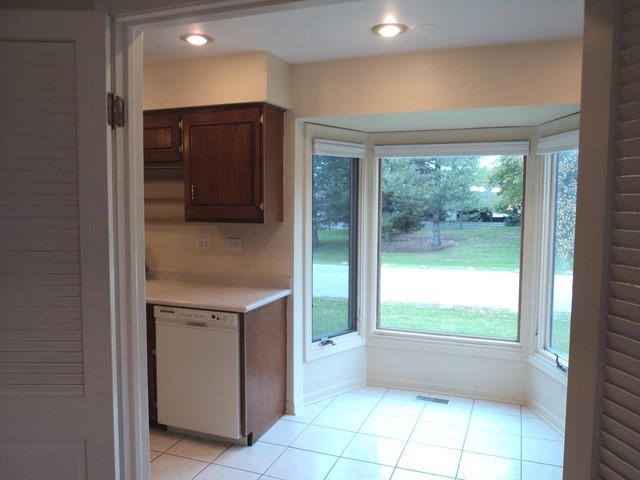 19-w286 Governors Trail Oak Brook, IL 60523 - Photo 5 of 17 a view of an empty room with a window and a kitchen view