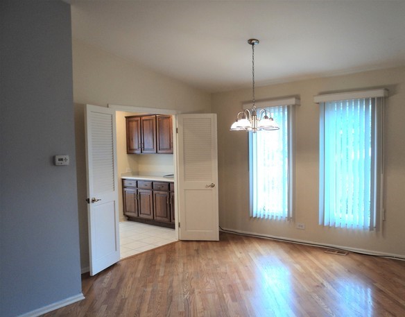 19-w286 Governors Trail Oak Brook, IL 60523 - Photo 7 of 17 a view of a kitchen with a stove wooden floor and window
