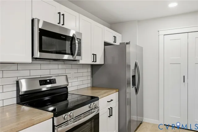 a kitchen with refrigerator and microwave