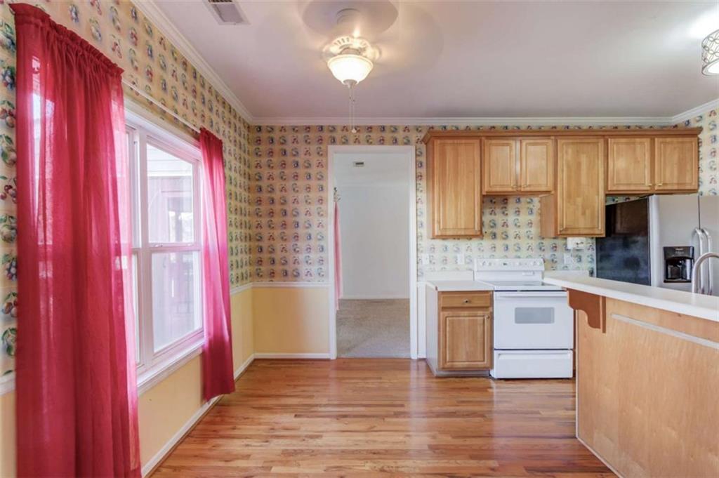 3322 Henderson View Court Southwest Loganville, GA 30052 - Photo 13 of 47 a view of a kitchen with a stove cabinets and wooden floor