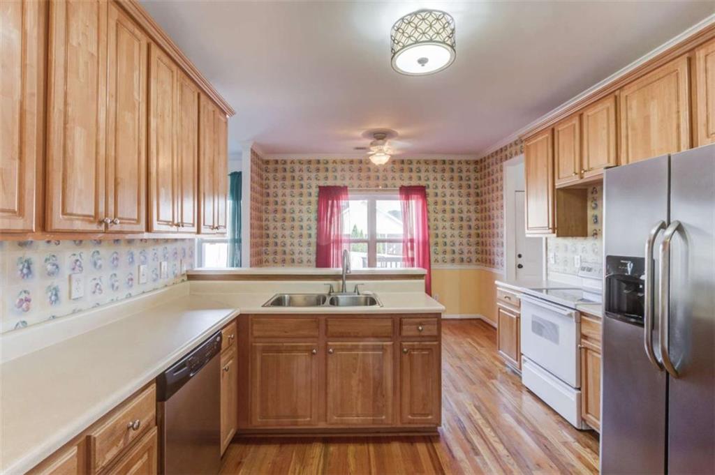 3322 Henderson View Court Southwest Loganville, GA 30052 - Photo 17 of 47 a kitchen with a sink stove and refrigerator