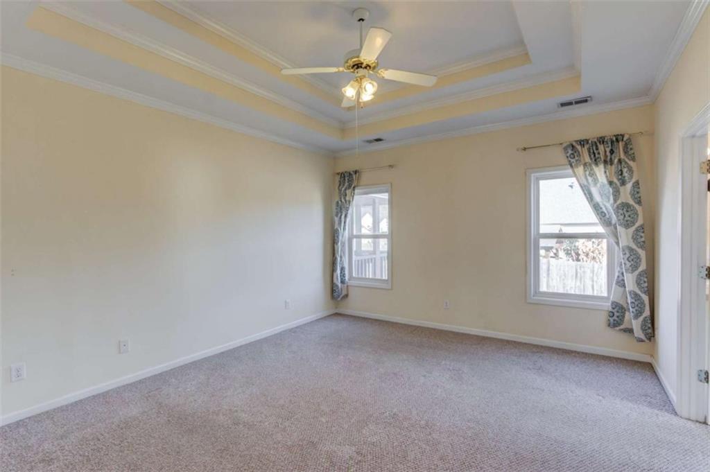 3322 Henderson View Court Southwest Loganville, GA 30052 - Photo 18 of 47 an empty room with windows and ceiling fan