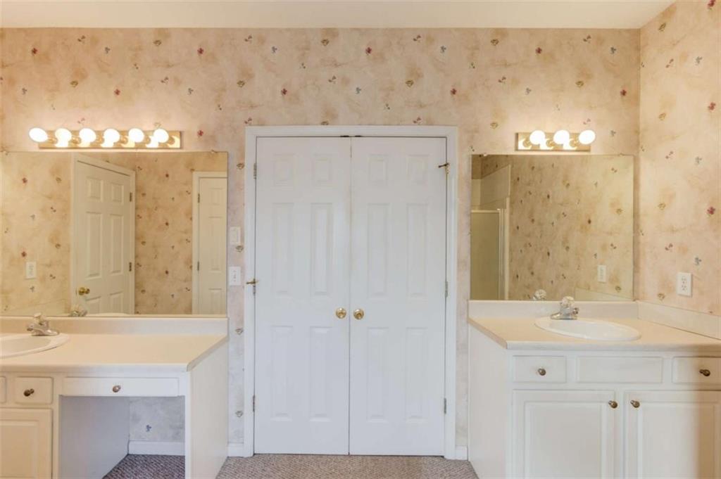 3322 Henderson View Court Southwest Loganville, GA 30052 - Photo 20 of 47 a bathroom with a sink a mirror and a shower