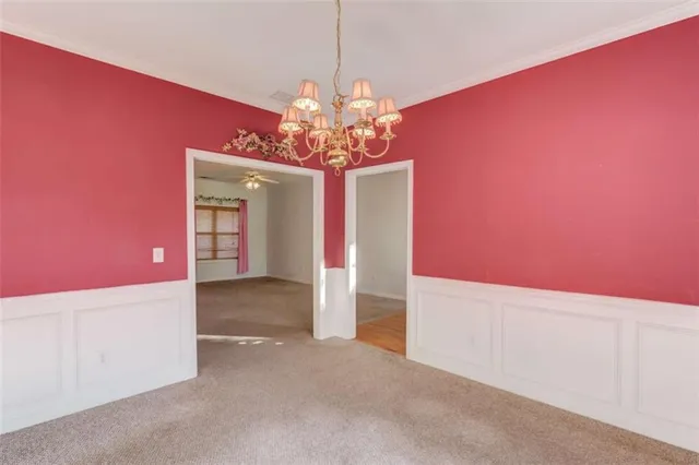 an empty room with a bathroom and a ceiling fan