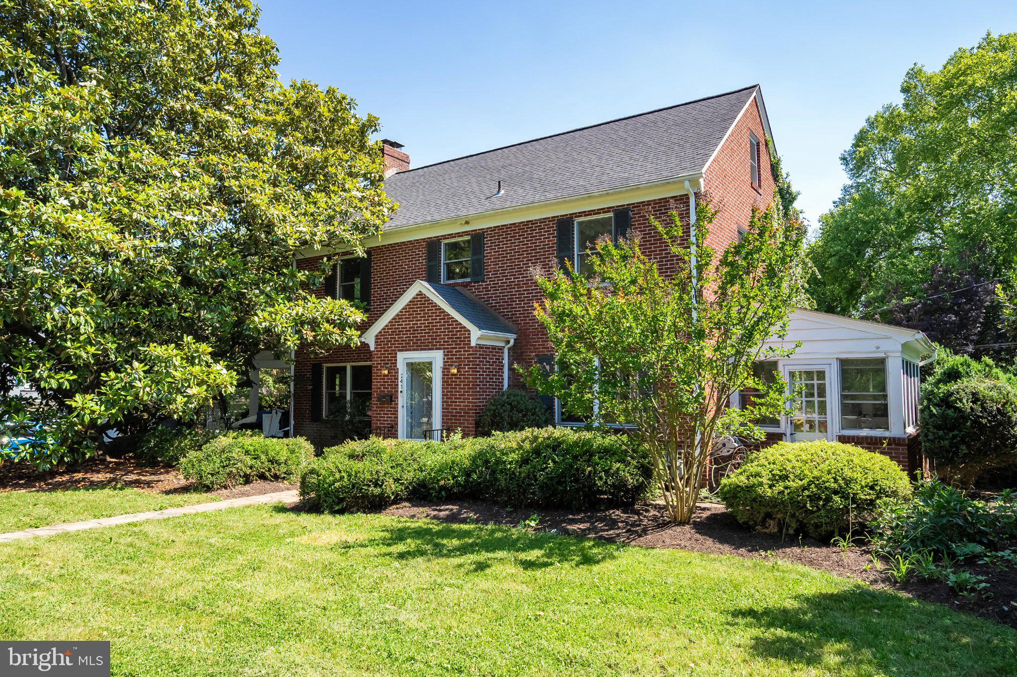 241 Edwards Ferry Road Northeast Leesburg, VA 20176 - Photo 1 of 27 Charming brick home with lush greenery.