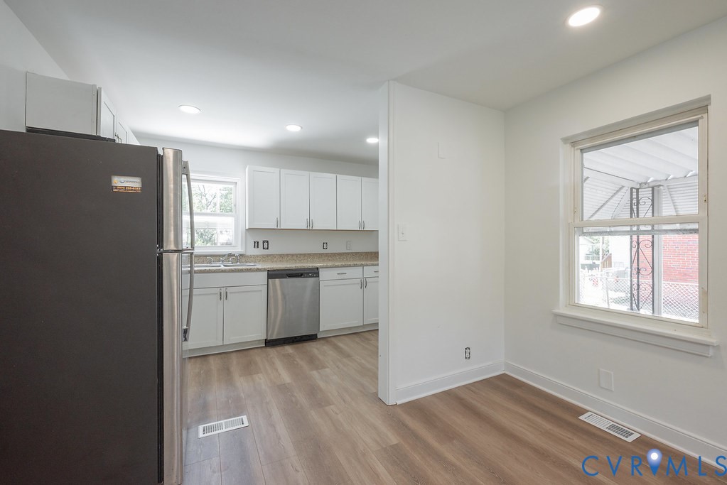 3400 Ryburn Road Richmond, VA 23234 - Photo 13 of 45 Kitchen featuring white cabinetry, light-toned cou