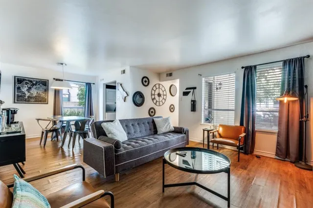 a living room with furniture and wooden floor