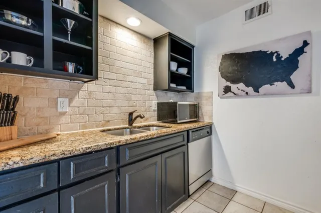 a kitchen with a sink and a microwave