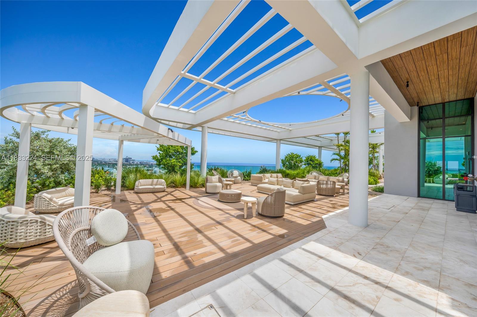 580 72nd Street, Unit 910 Miami Beach, FL 33141 - Photo 14 of 60 a view of a patio with couches and potted plants