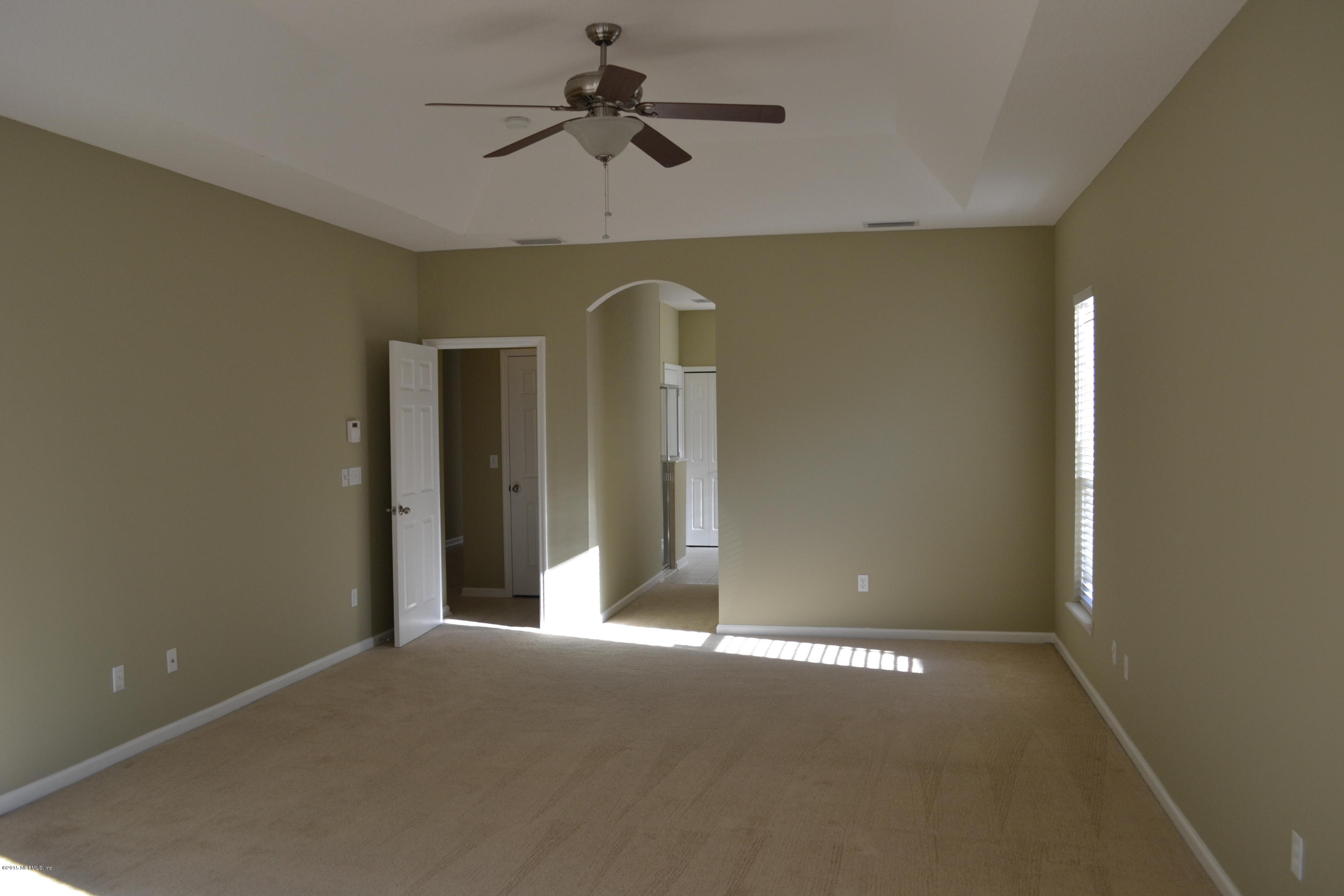 14422 Millhopper Road Jacksonville, FL 32258 - Photo 18 of 65 a view of a livingroom with a ceiling fan and window