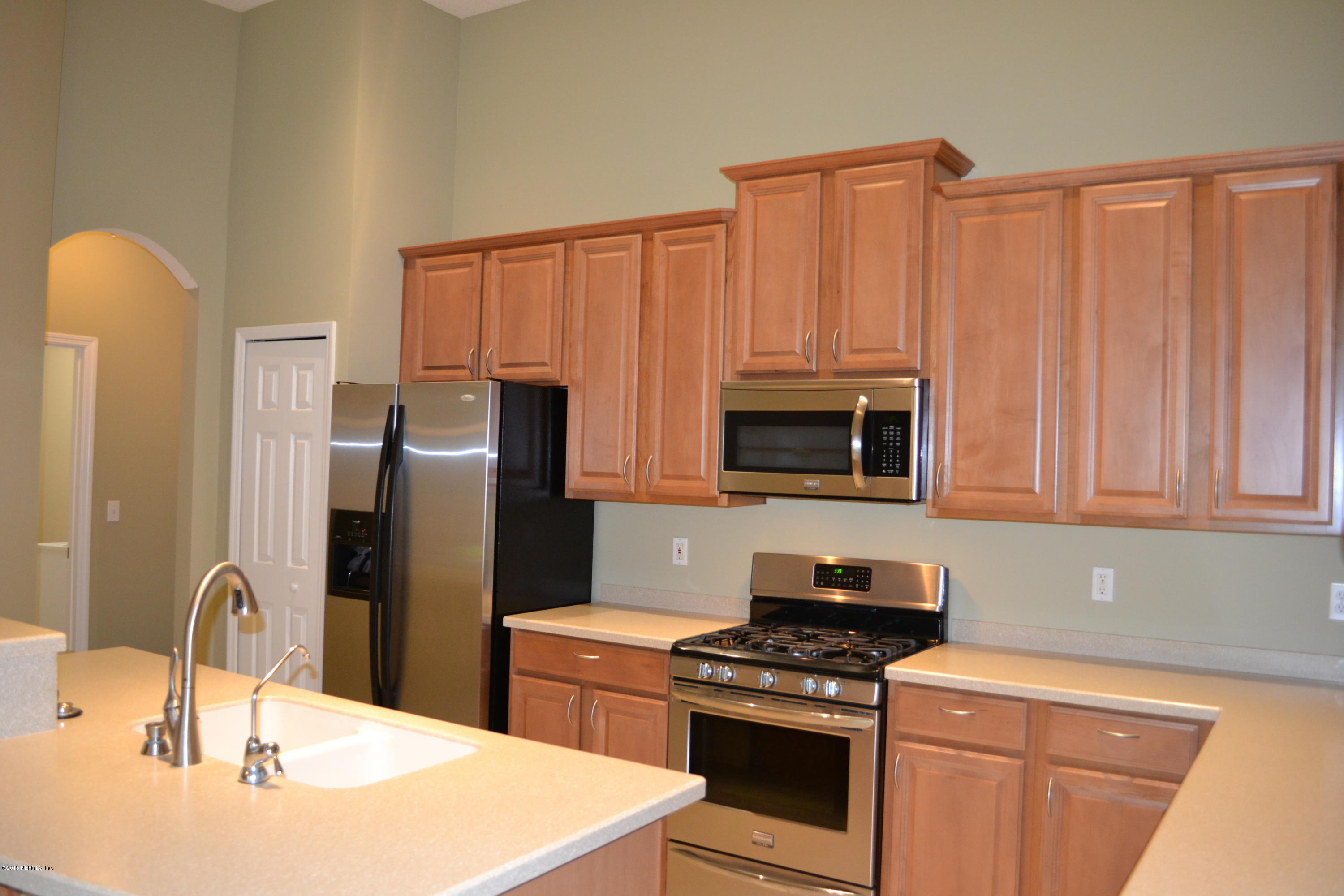 14422 Millhopper Road Jacksonville, FL 32258 - Photo 25 of 65 a kitchen with stainless steel appliances granite countertop a refrigerator stove and sink