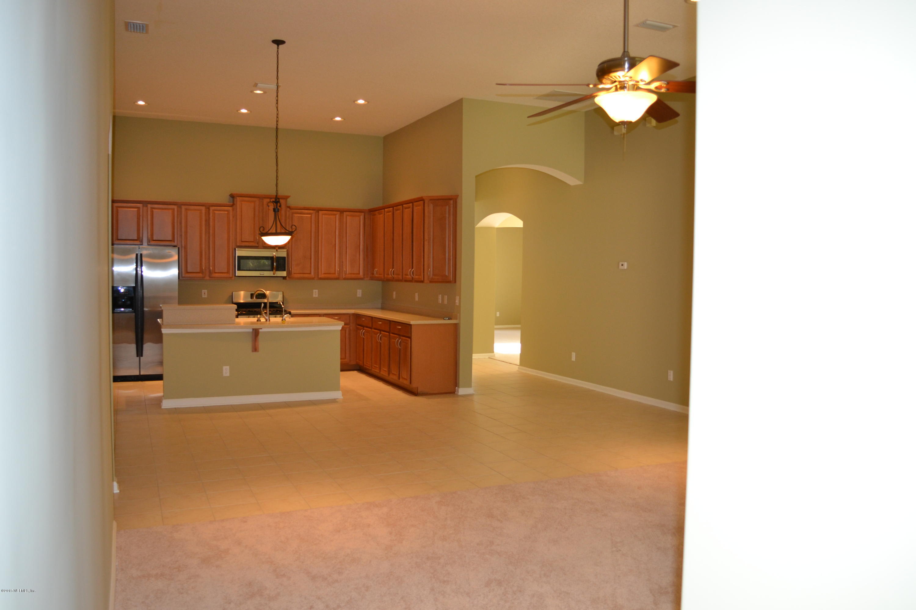 14422 Millhopper Road Jacksonville, FL 32258 - Photo 26 of 65 a view of a kitchen with a sink and refrigerator