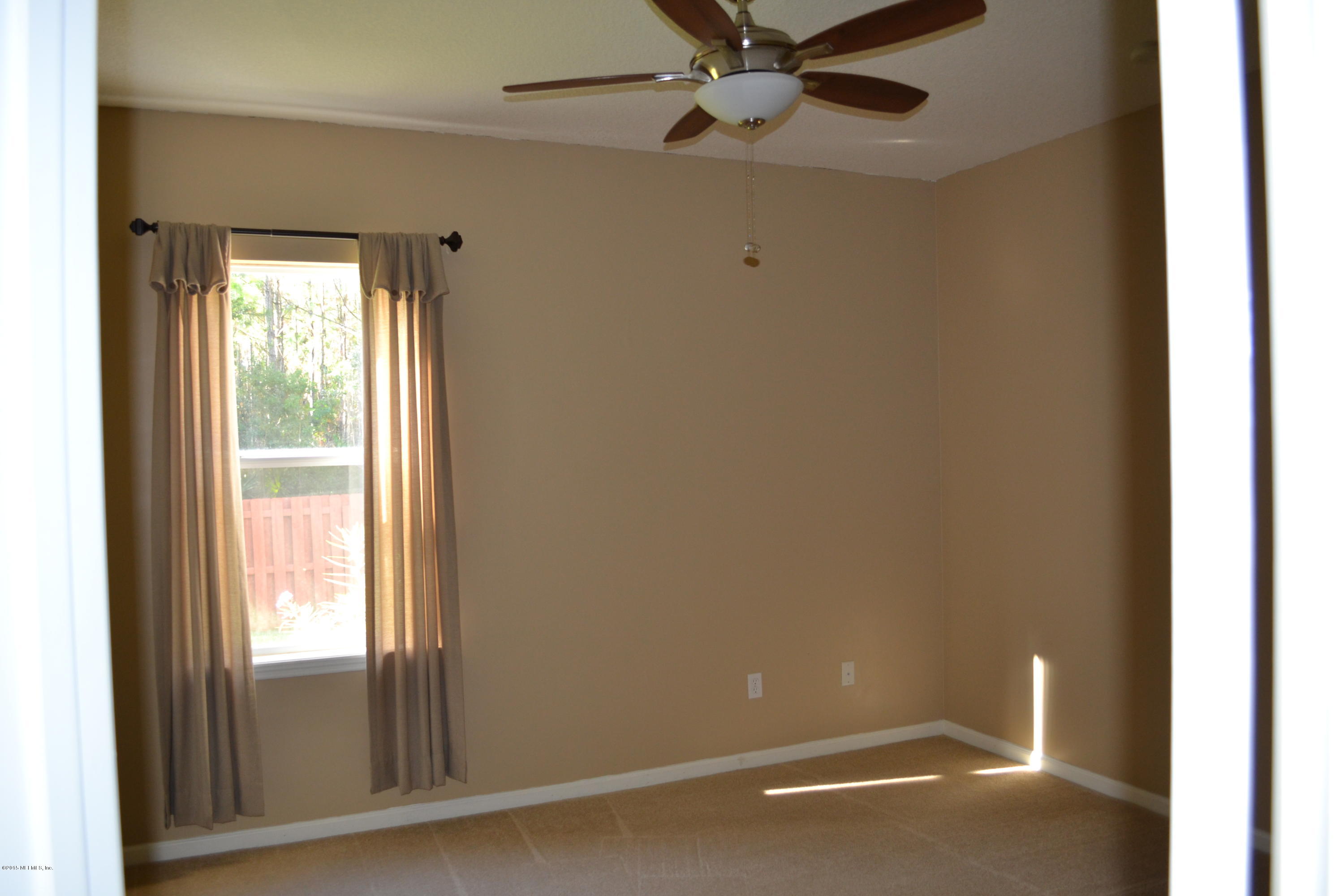 14422 Millhopper Road Jacksonville, FL 32258 - Photo 34 of 65 a view of an empty room with a window