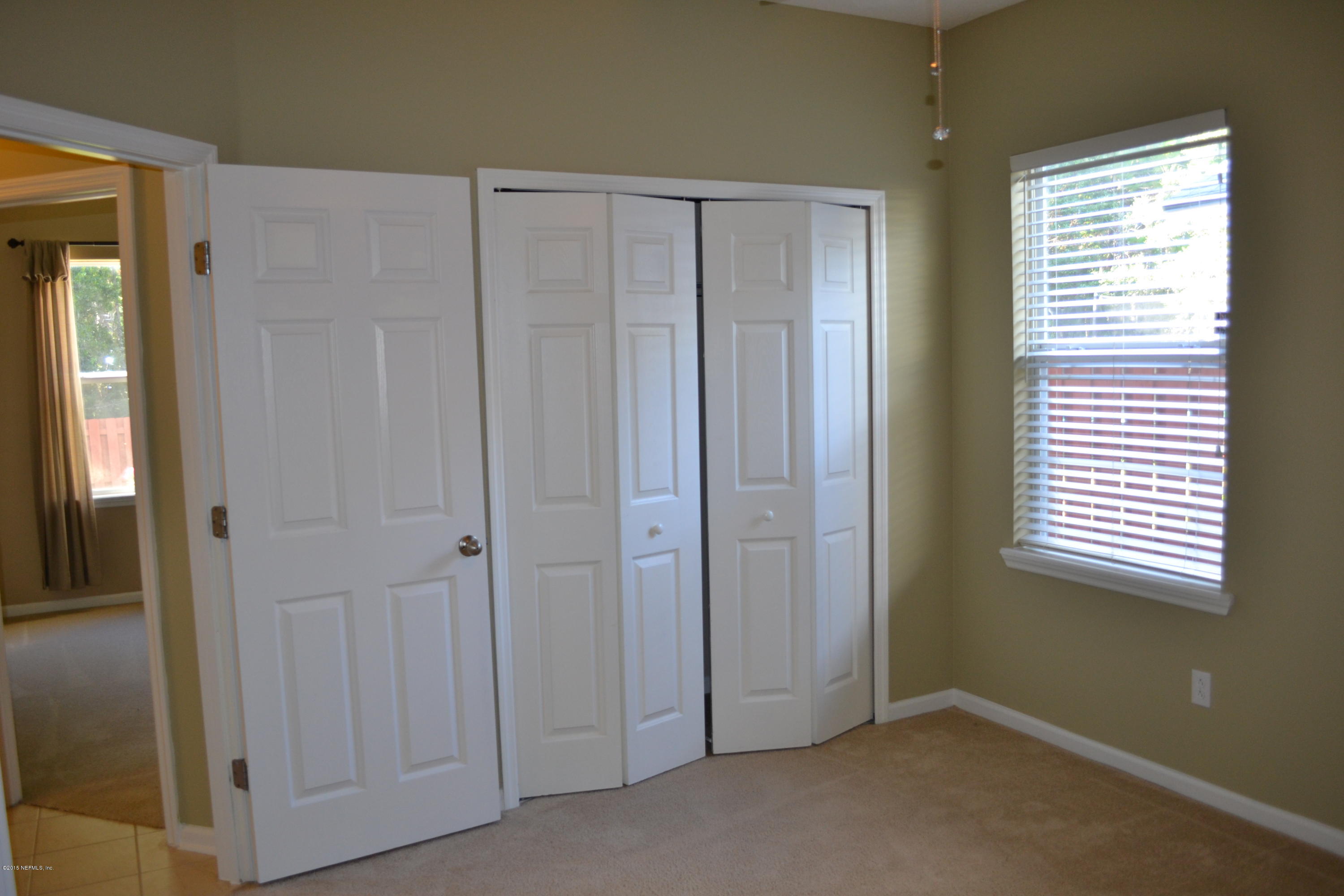 14422 Millhopper Road Jacksonville, FL 32258 - Photo 36 of 65 an empty room with windows